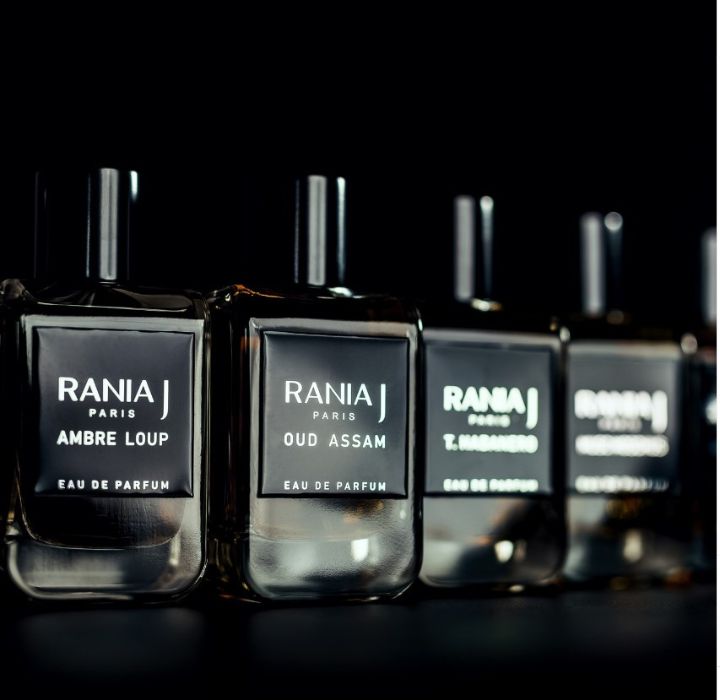 4 flacons de la marque de parfums de niche RANIA J sur un fond noir, parmi lesquels "Ambre Loup" et "Oud Hassam" sur Scentissime